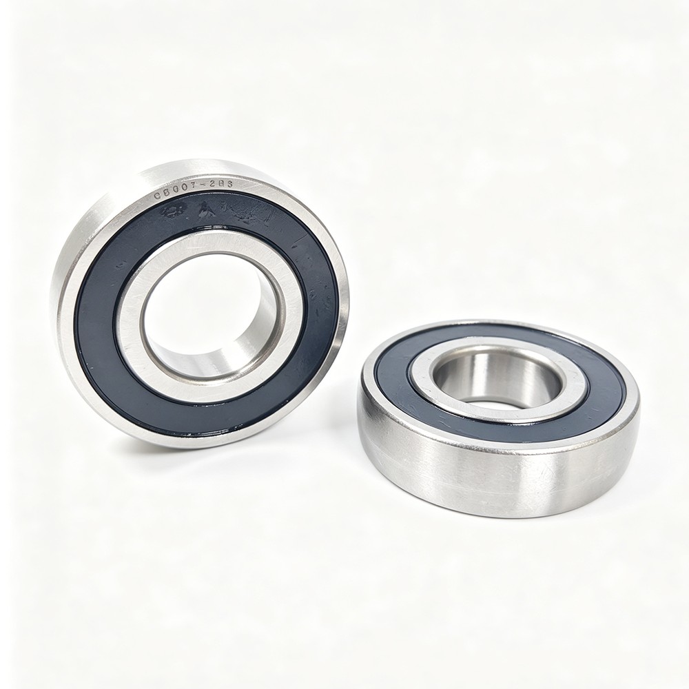 Product Features - Double 2RS rubber seals: dust-proof, waterproof and oil-locking, suitable for harsh working conditions - High-strength bearing steel material: wear-resistant, anti-fatigue and long service life - Low noise and smooth operation: optimized raceway process for stable high-speed operation - Heavy load capacity: suitable for continuous operation and impact load scenarios - Maintenance-free design: long-term grease storage, reduce maintenance frequency Application Scope CB307-2RS track roller bearings are widely applied in automated production lines, cam machinery, linear guide systems, conveyor equipment, packaging machinery, textile machinery and other mechanical transmission fields, providing stable and reliable rolling support for industrial equipment..jpeg Product Features - Double 2RS rubber seals: dust-proof, waterproof and oil-locking, suitable for harsh working conditions - High-strength bearing steel material: wear-resistant, anti-fatigue and long service life - Low noise and smooth operation: optimized raceway process for stable high-speed operation - Heavy load capacity: suitable for continuous operation and impact load scenarios - Maintenance-free design: long-term grease storage, reduce maintenance frequency Application Scope CB307-2RS track roller bearings are widely applied in automated production lines, cam machinery, linear guide systems, conveyor equipment, packaging machinery, textile machinery and other mechanical transmission fields, providing stable and reliable rolling support for industrial equipment..jpeg